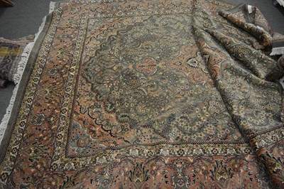 Lot 555 - A large Persian carpet.