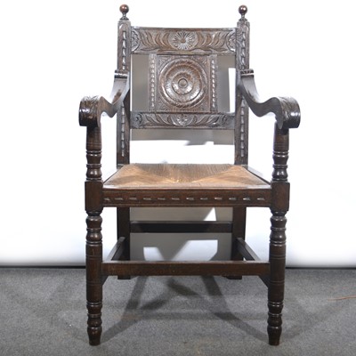 Lot 424 - Victorian carved oak elbow chair.