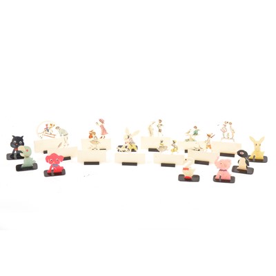 Lot 343 - Eighteen novelty plastic place settings, ivorine with coloured animals and figures.