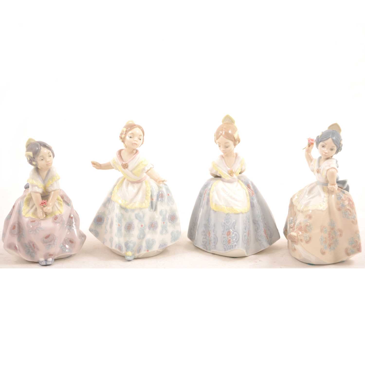Lot 16 - A set of four small Lladro figures of girls.