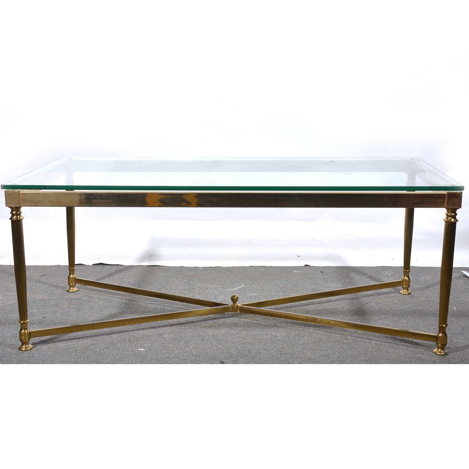 Lot 25 - A modern brass finish and plate glass coffee table.