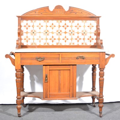 Lot 84 - A Victorian walnut tile-backed washstand.