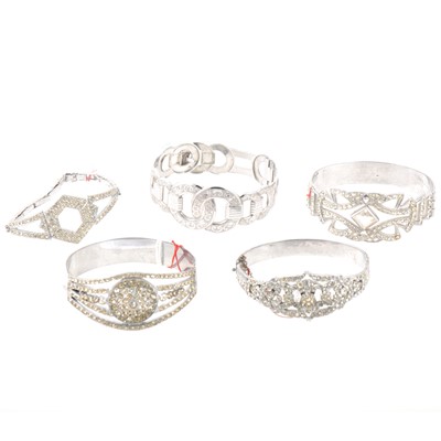 Lot 280 - Four paste set costume jewellery bangles and another rhodium plated, cocktail watch, brooches.