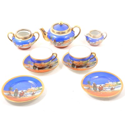 Lot 62 - Continental porcelain tea service with an Arabian desert scene.
