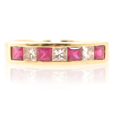 Lot 197 - Ruby and diamond half eternity ring, 18 carat gold.