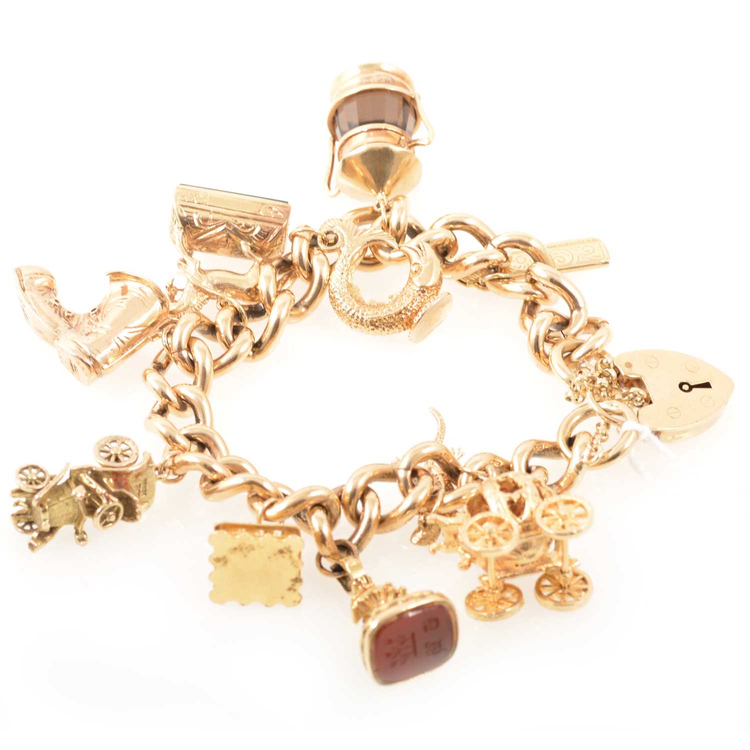 Lot 204 - Heavy 9 carat gold charm bracelet with ten charms including two seals.