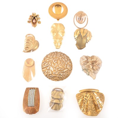 Lot 252 - Twelve 1930's gilt metal dress clips, floral, leaf and Art Deco designs.