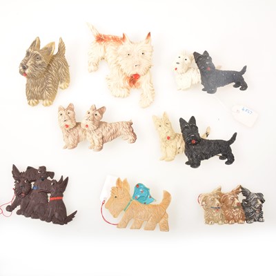 Lot 263 - Eight vintage celluloid and plastic Scottie dog brooches, five with articulated heads.