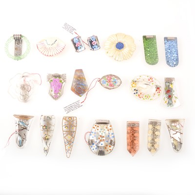 Lot 277 - Eighteen mostly clear glass brooches and dress clips, pair of earrings, painted decoration.