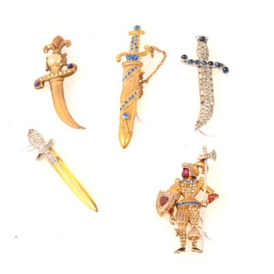 Lot 247 - Four sword/dagger brooches, lucite, paste and a silver-gilt knight