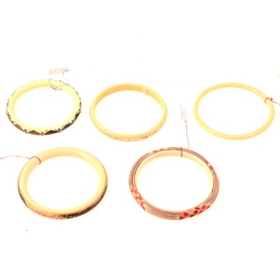 Lot 269 - Five vintage celluloid ivorine bangles, coloured and set with paste.