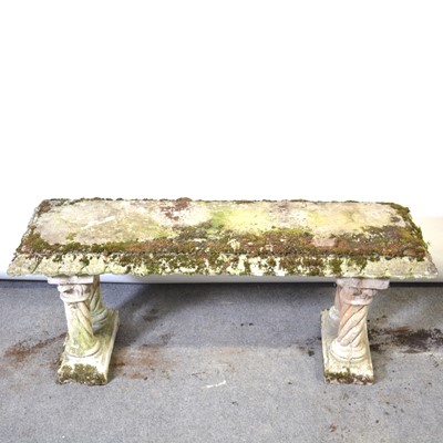 Lot 224 - A reconstituted stone garden bench, straight rectangular top, on twin supports.