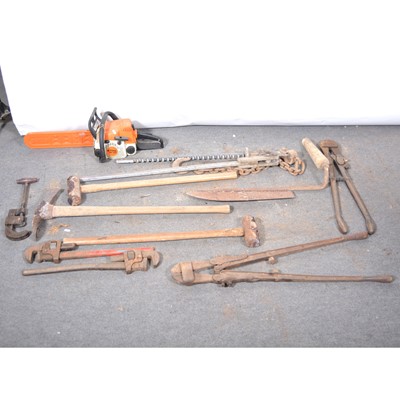 Lot 56 - Two sledge hammers, a pick axe, two bolt croppers, two bolt wrenches, pipe cutter, chain saw, still iron, silage cutter and a post stretcher.