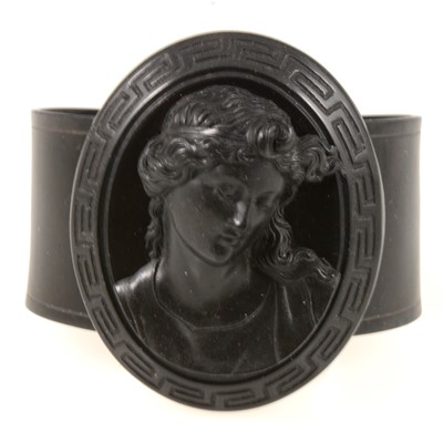 Lot 373 - Early celluloid mourning flexible cuff bangle with oval cameo to front.