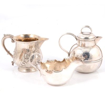 Lot 219 - Two silver cream jugs and a sauceboat
