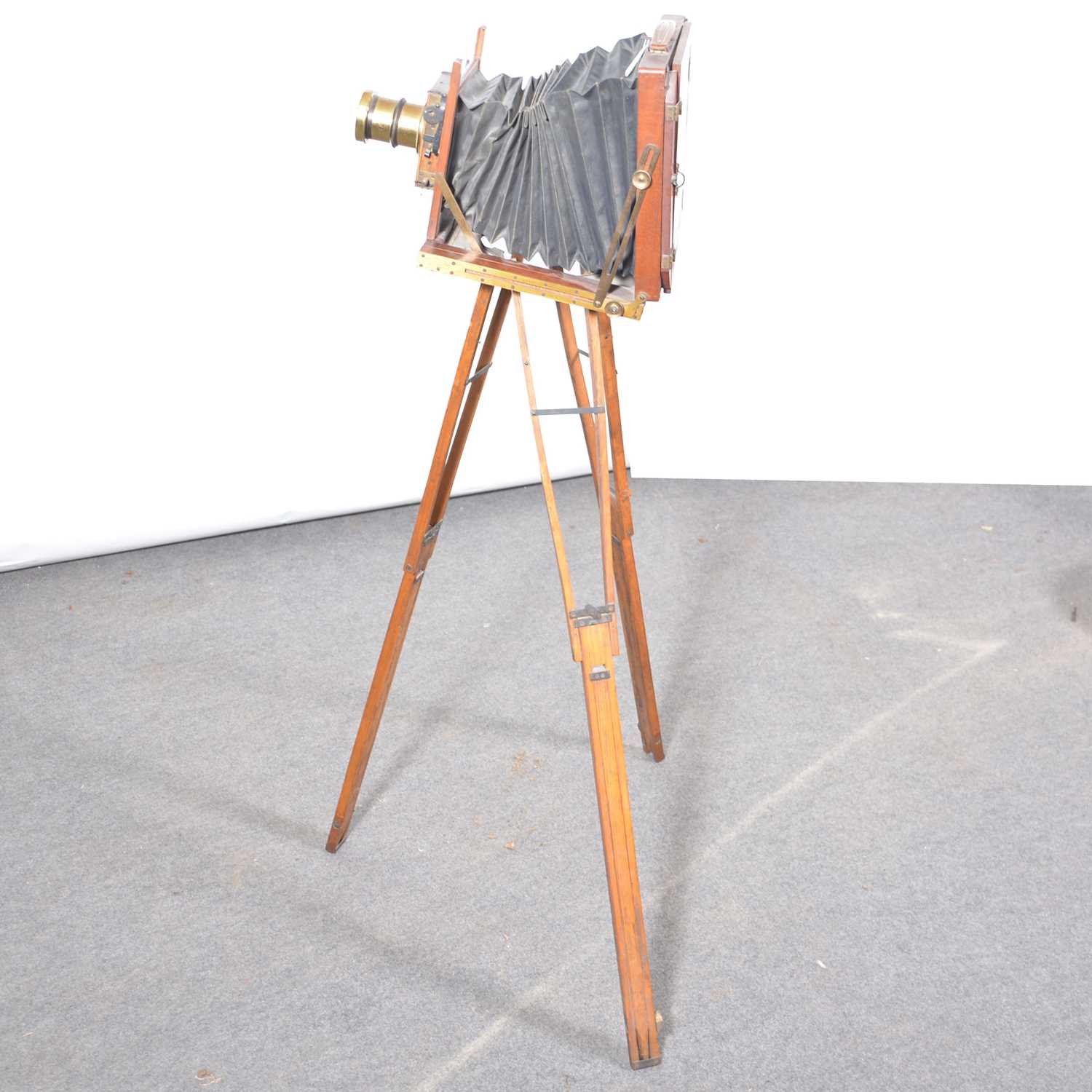 Lot 171 - Mahogany folding plate camera, on a tripod stand.