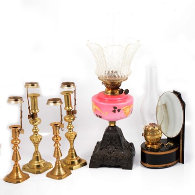 Lot 101 - Two pairs of brass candlesticks, a Toleware reflector oil lamp, and another oil lamp.