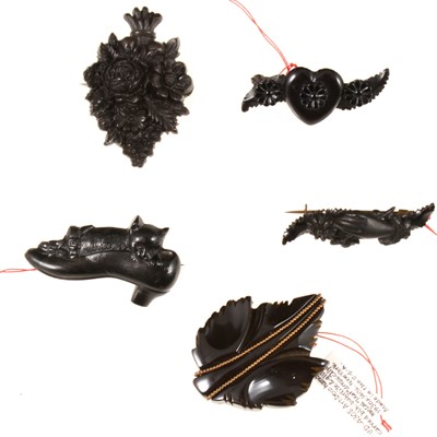 Lot 372 - Four simulated jet brooches and one dress clip.