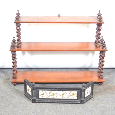 Lot 568 - A mahogany bookrack with barley twist supports, and a cast iron tiled fender