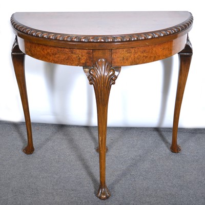 Lot 625 - A walnut veneer demi-lune card table