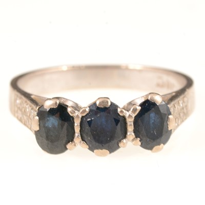 Lot 302 - A sapphire three stone ring, mount marked 18ct.