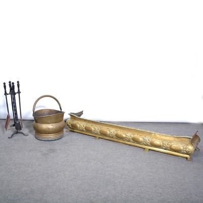 Lot 569 - A brass fender, on paw feet; and a set of firside tools and coal scuttle.