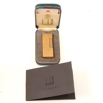 Lot 316 - Dunhill - a gold-plated cigarette lighter, engine turned in the  Florentine design