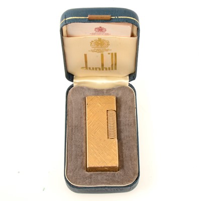 Lot 316 - Dunhill - a gold-plated cigarette lighter, engine turned in the  Florentine design