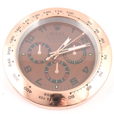 Lot 388 - Rolex Oyster Perpetual dealers display clock, copper coloured dial with rose metal bezel.