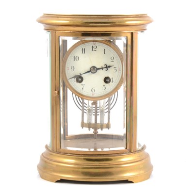 Lot 82 - Brass oval four glass mantel clock.