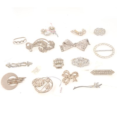 Lot 310 - Fifteen vintage clear paste brooches, dress clips, buckle and clasp.