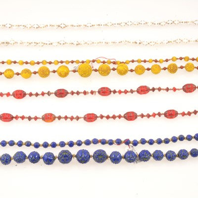 Lot 296 - Four coloured pressed glass necklaces, circa 1920.