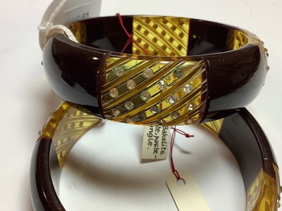 Lot 286 - Pair of vintage bakelite and lucite bangles set with clear paste.