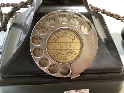 Lot 172 - Vintage black bakelite telephone and a modern clock.