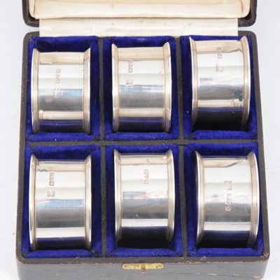 Lot 238 - Cased set of six silver napkin rings by Barker Brothers, Chester 1913.