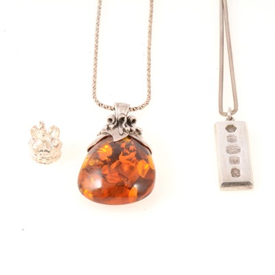 Lot 310 - Silver ingot, amber pendant and charm.