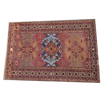 Lot 581 - Modern rug with mauve ground.