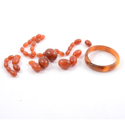 Lot 211 - Amber coloured bead necklace and a bakelite type crossover bangle.