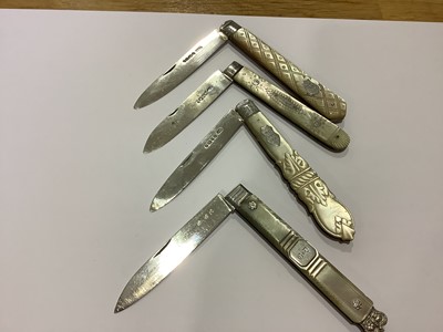 Lot 154 - Four mother-of-pearl and silver folding fruit knives.