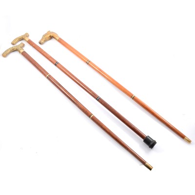 Lot 141 - Three walking sticks, brass handles, one with glass flask.