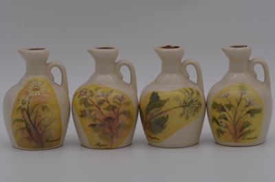Lot 124 - Twenty four assorted Rutherford's white ceramic decanters, Garden birds and herbs series