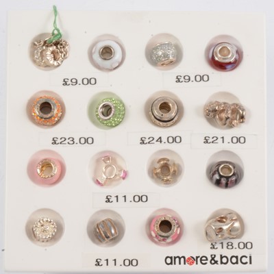 Lot 252 - Amore & Baci - sixteen silver bead charms on branded display stand.