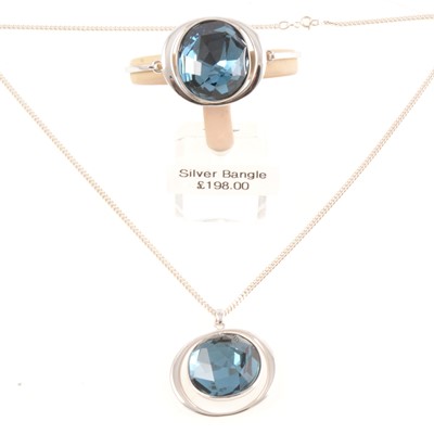 Lot 204 - Matching new silver bangle and pendant with a large faux blue topaz.