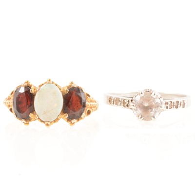 Lot 175 - Two gold dress rings, opal and garnet, solitaire synthetic clear stone.