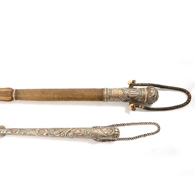 Lot 119 - Two North African camel whips