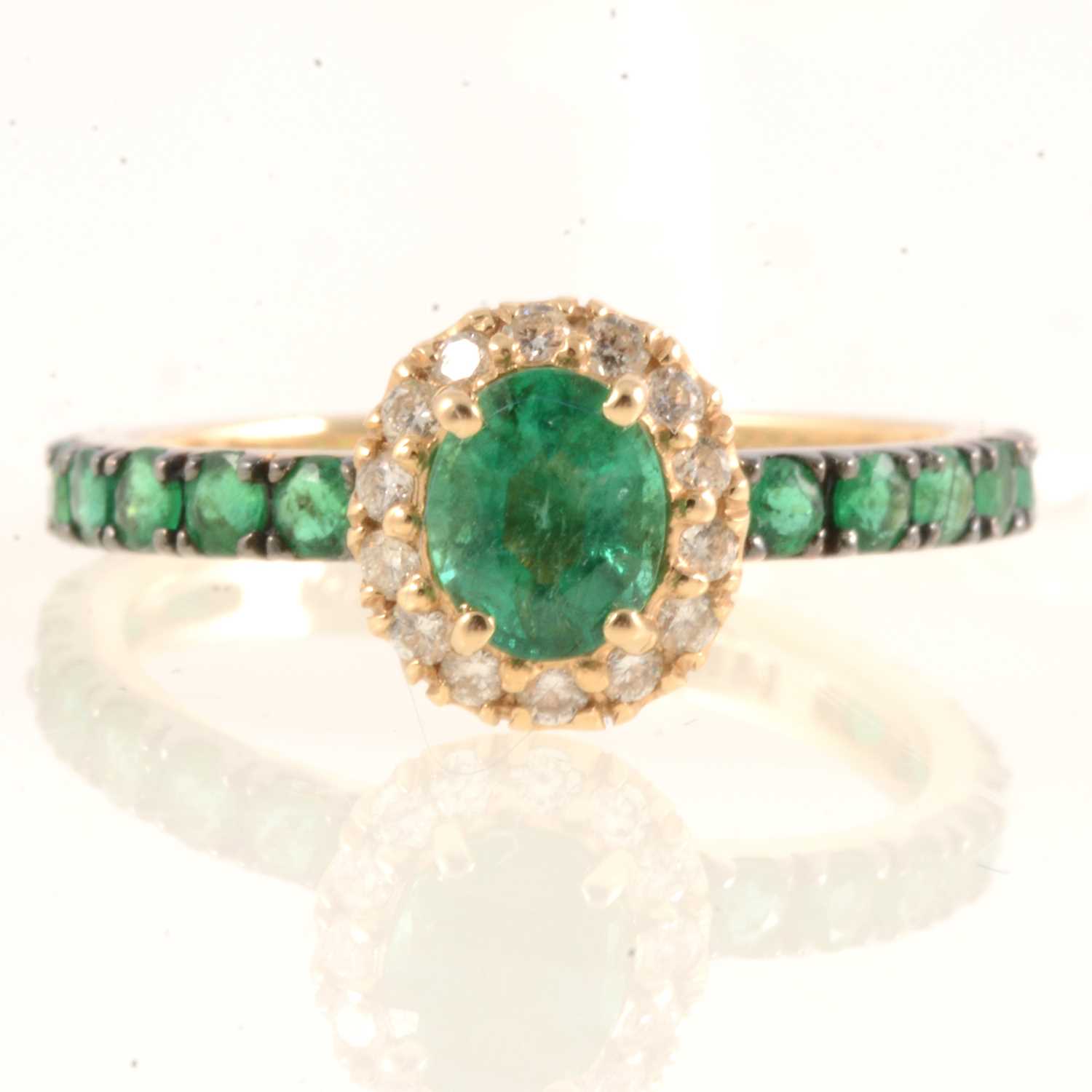 Lot 165 - Effy - An oval emerald and diamond cluster ring.