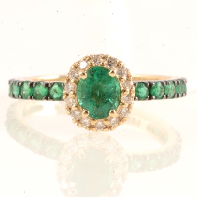 Lot 165 - Effy - An oval emerald and diamond cluster ring.