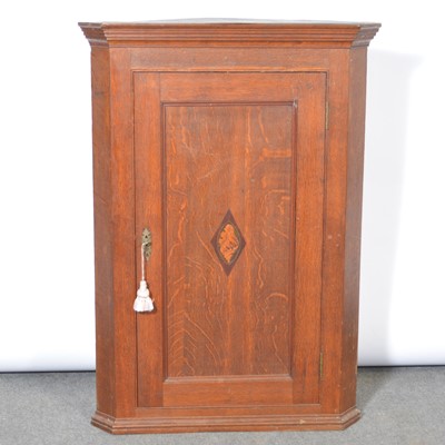 Lot 317 - George III oak hanging corner cupboard