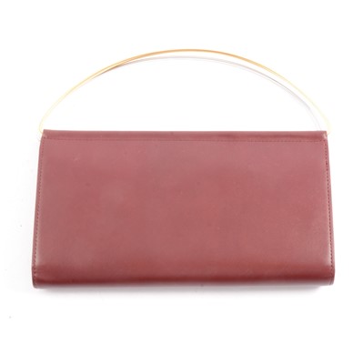 Lot 214 - Cartier - A Mini Trinity Clutch Bag in Burgundy, Boxed with certificate.