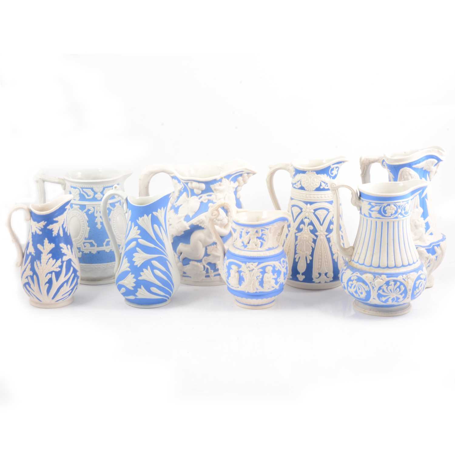 Lot 39 - Eight Victorian relief-moulded jugs, various makers.